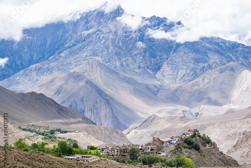 Tibetan village and Dhaulagiri mountain range on background.