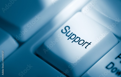 Support business concept displayed as key action on blue toned computer keyboard