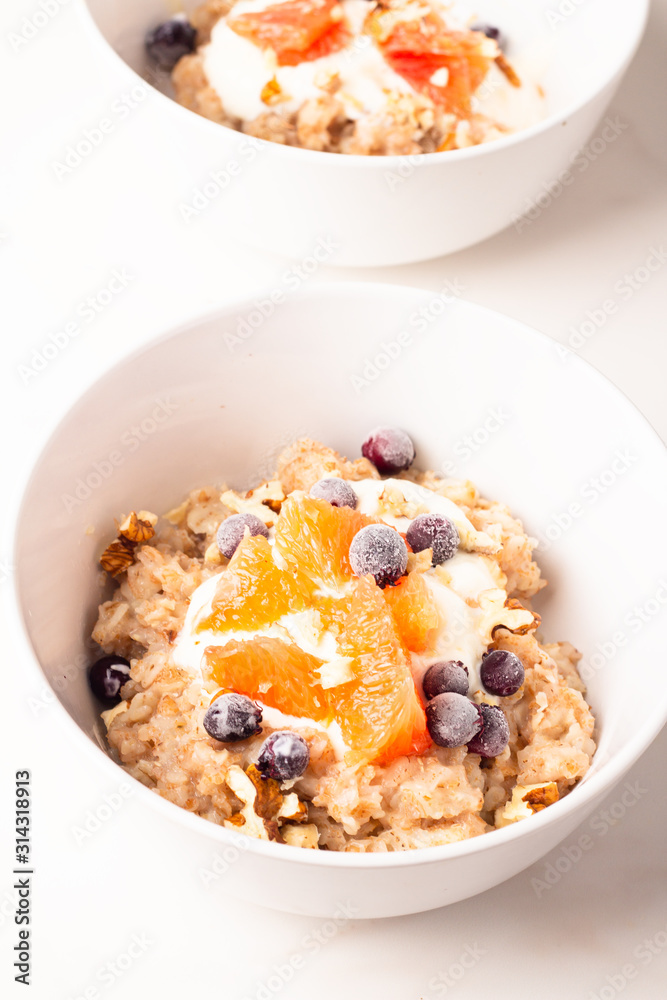 oatmeal with fruit and coffee for breakfast on a white background oatmeal with fruit and coffee for breakfast on a white background