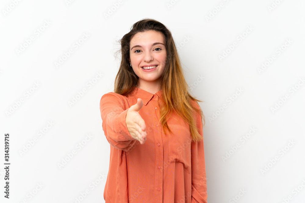 Young brunette girl over isolated white background shaking hands for closing a good deal Young brunette girl over isolated white background shaking hands for closing a good deal