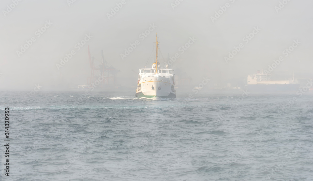 Beautiful View touristic landmarks from sea voyage on Bosphorus. Turkish steamboats hiding in fog.view on Golden Horn.