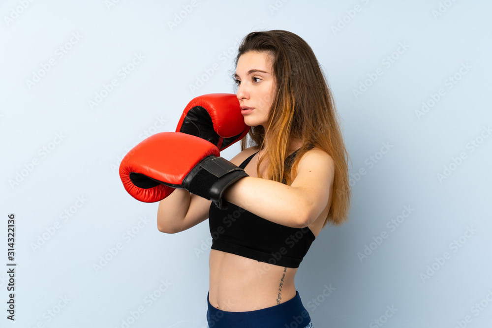 Young brunette girl with boxing gloves over isolated background Young brunette girl with boxing gloves over isolated background