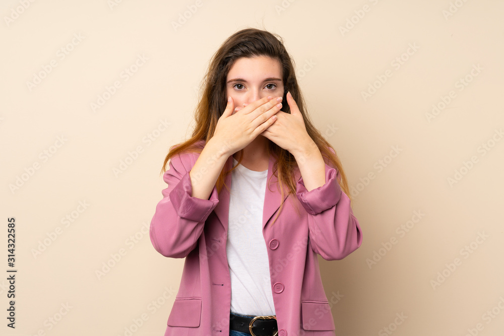 Young brunette girl with blazer over isolated background covering mouth with hands Young brunette girl with blazer over isolated background covering mouth with hands