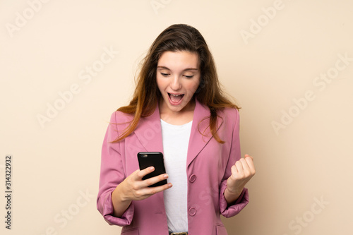 Young brunette girl with blazer over isolated background surprised and sending a message