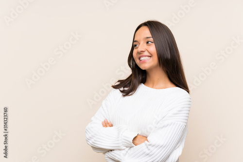 Young brunette woman with white sweater over isolated background looking to the side