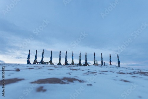 Columns with colorful ribbons on Cape Burhan. Lake Baikal landscape photo