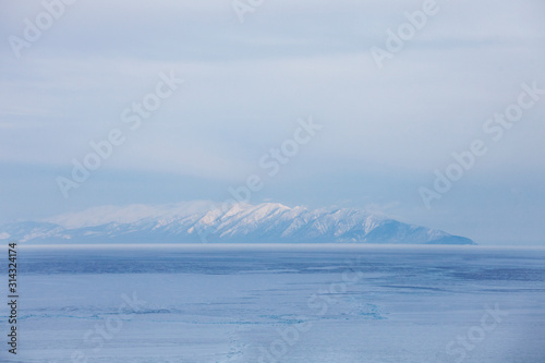 Baikal lake. Snowy mountain peaks, winter landscape.