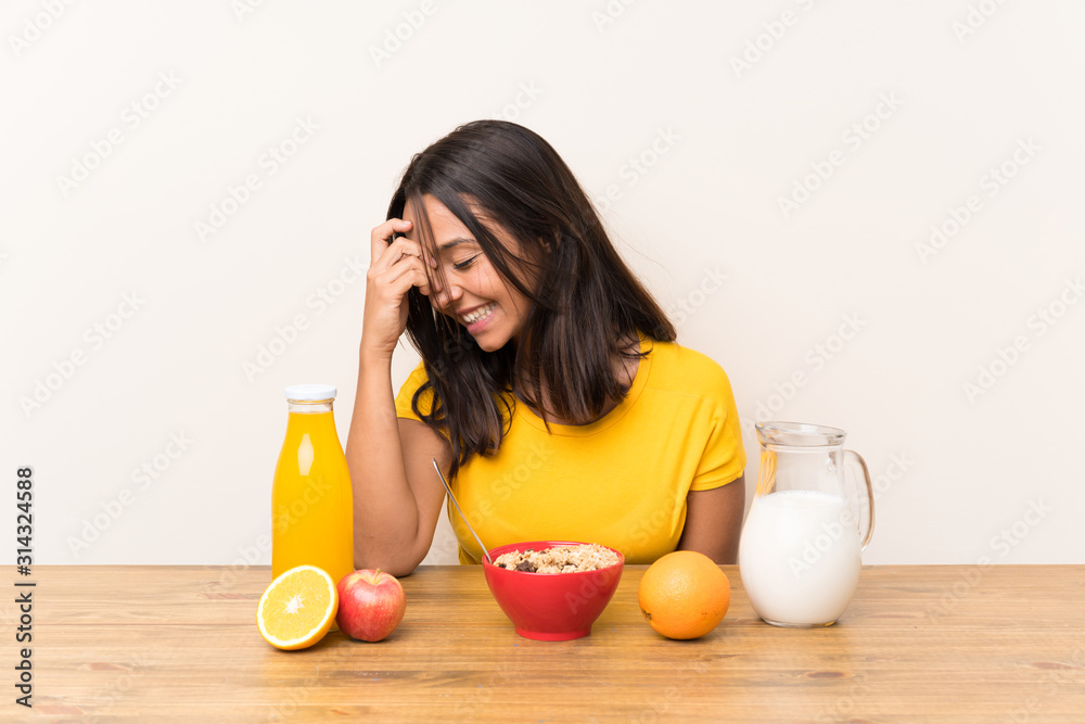 Young brunette girl having breakfast milk laughing Young brunette girl having breakfast milk laughing
