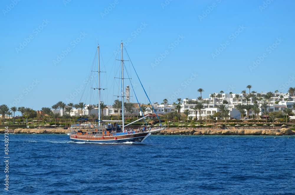Red sea boat with sails