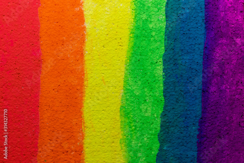 Vertical rainbow stripes of red, orange, yellow, green, cyan, blue and violet on the Styrofoam texture. Сolor watercolor background.