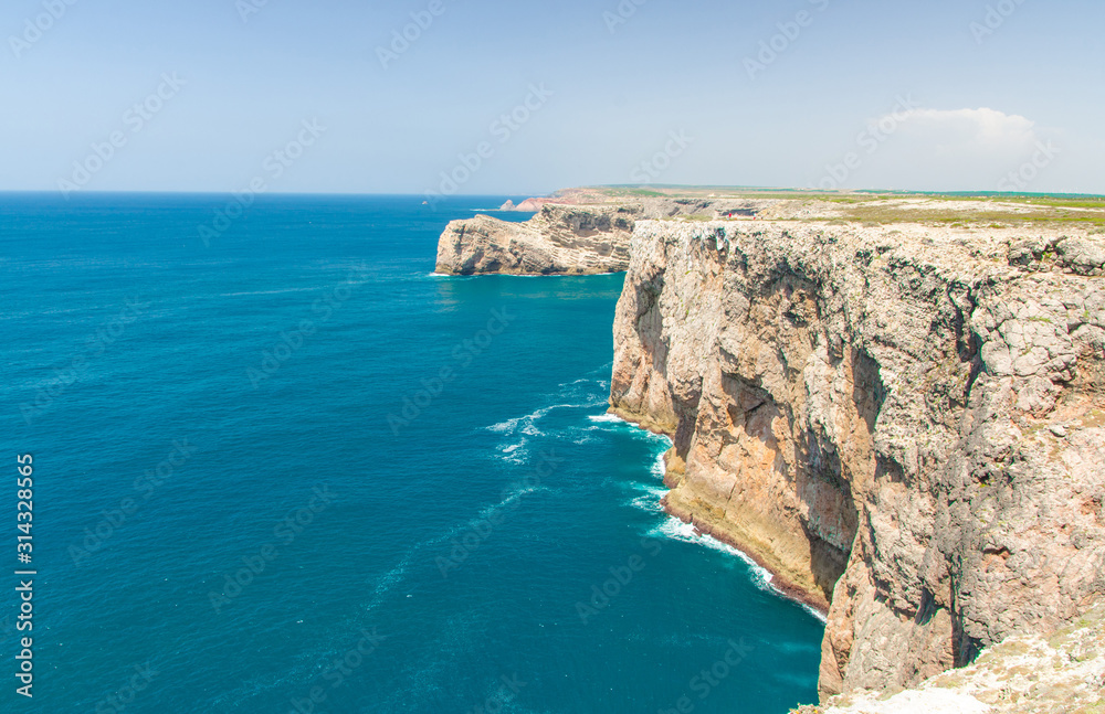 Portugal, Algarve, view of famous cliffs of Moher and wild Atlantic Ocean, Portuguese coastline close to Cape St. Vincent on a sunny and clear day with The blue Atlantic  in the background