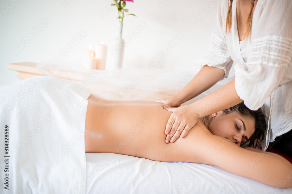 Fototapeta premium Young girl in spa massage on holiday