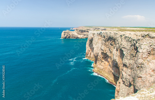 Portugal, Algarve, view of famous cliffs of Moher and wild Atlantic Ocean, Portuguese coastline close to Cape St. Vincent on a sunny and clear day with The blue Atlantic  in the background