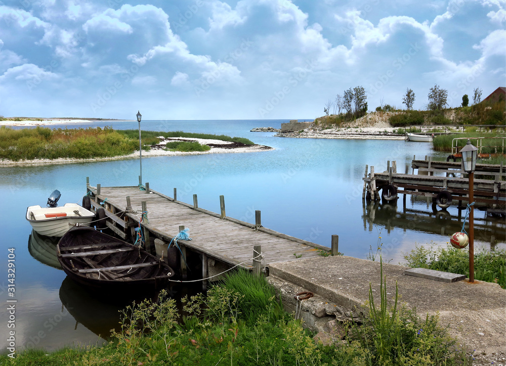 Tranquil picturesque small boat marina in calm condition with a looming storm further out at sea