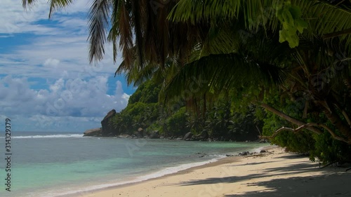 Ocean waves palm trees and granite rocks - Seychelles Mahe Island