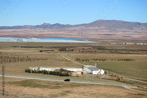 View of the valley in sierra nevada mountains with agricultural buildings