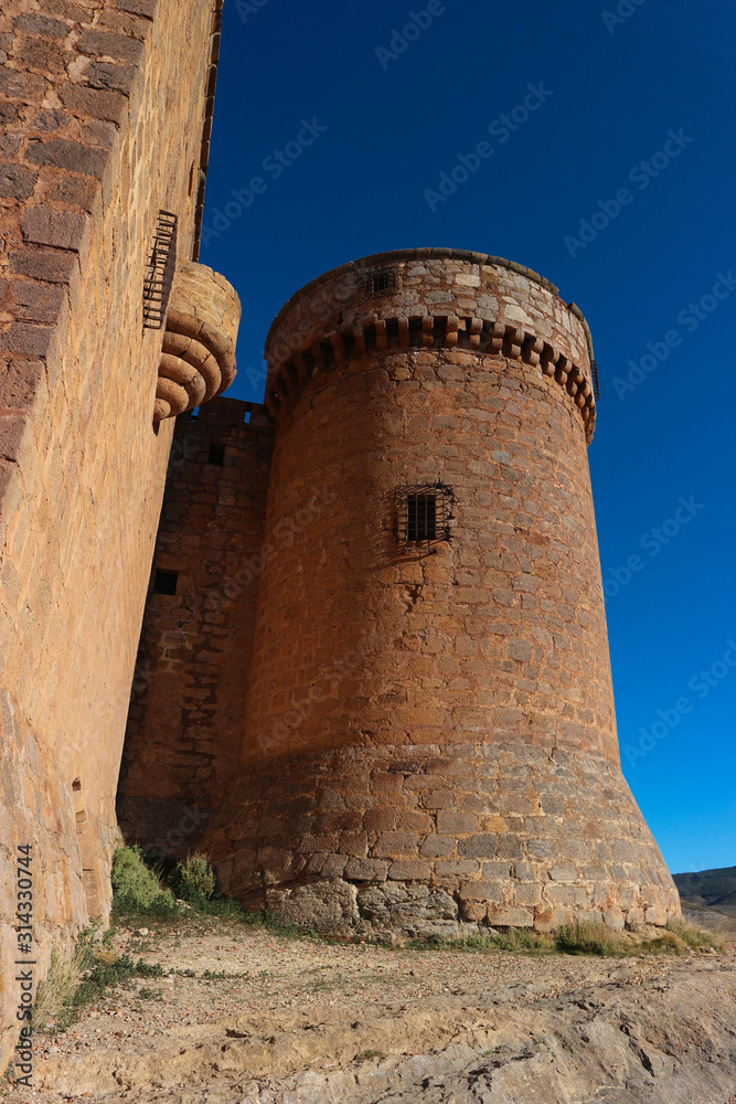 tower of old medieval spanish castle La Calahorra, Andalucia, Spain against blue sky