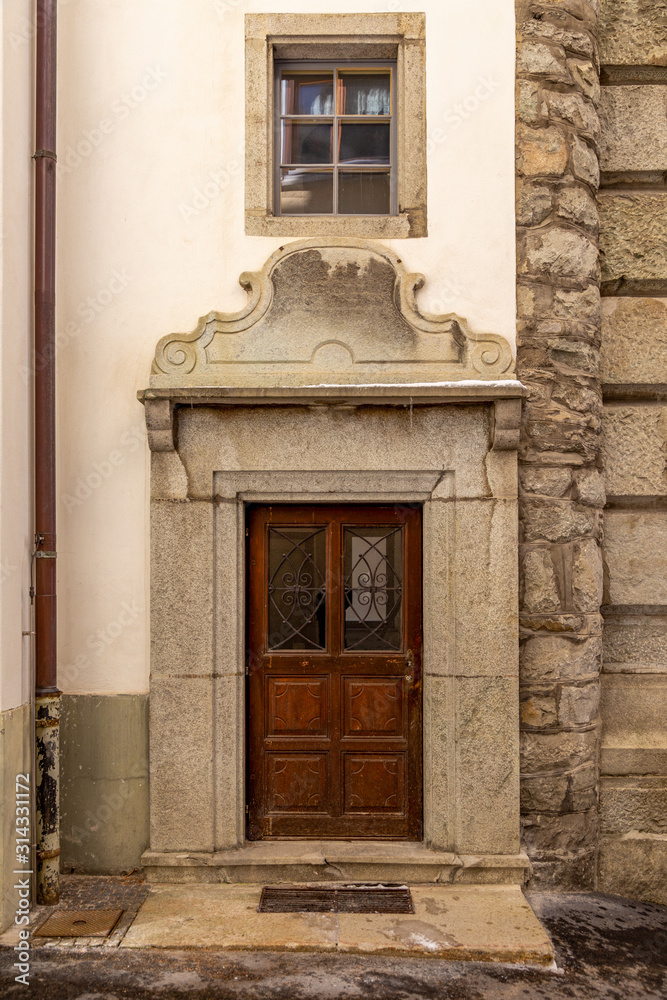 wooden door with ancient stone decorations, Swiss