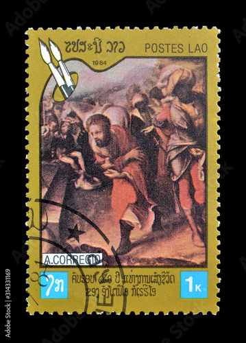 Cancelled postage stamp printed by Laos, that shows Painting with religious motives by Corregio, circa 1984. photo