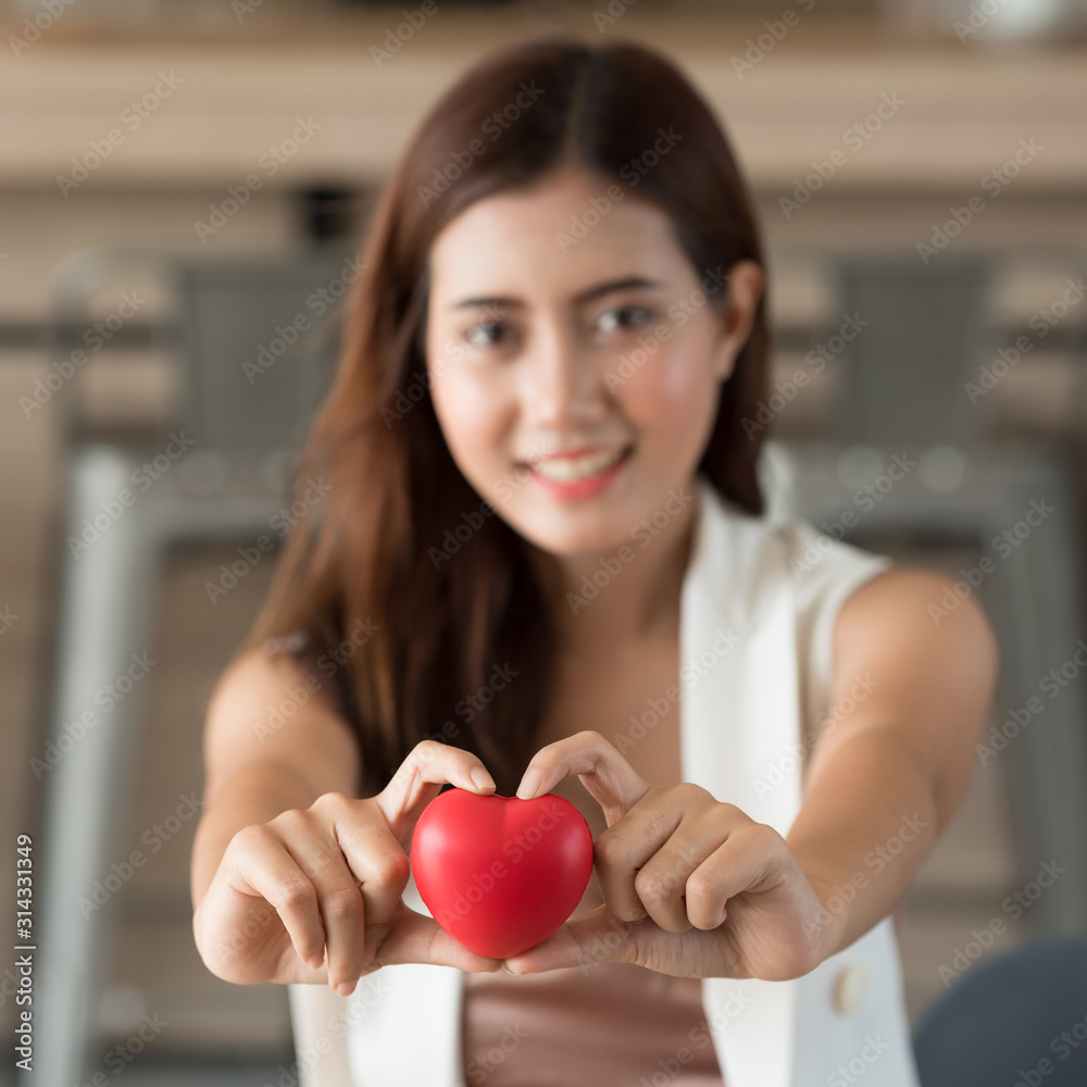 Young Asian woman holding giving heart in valentine day. Young Asian woman holding giving heart in valentine day.