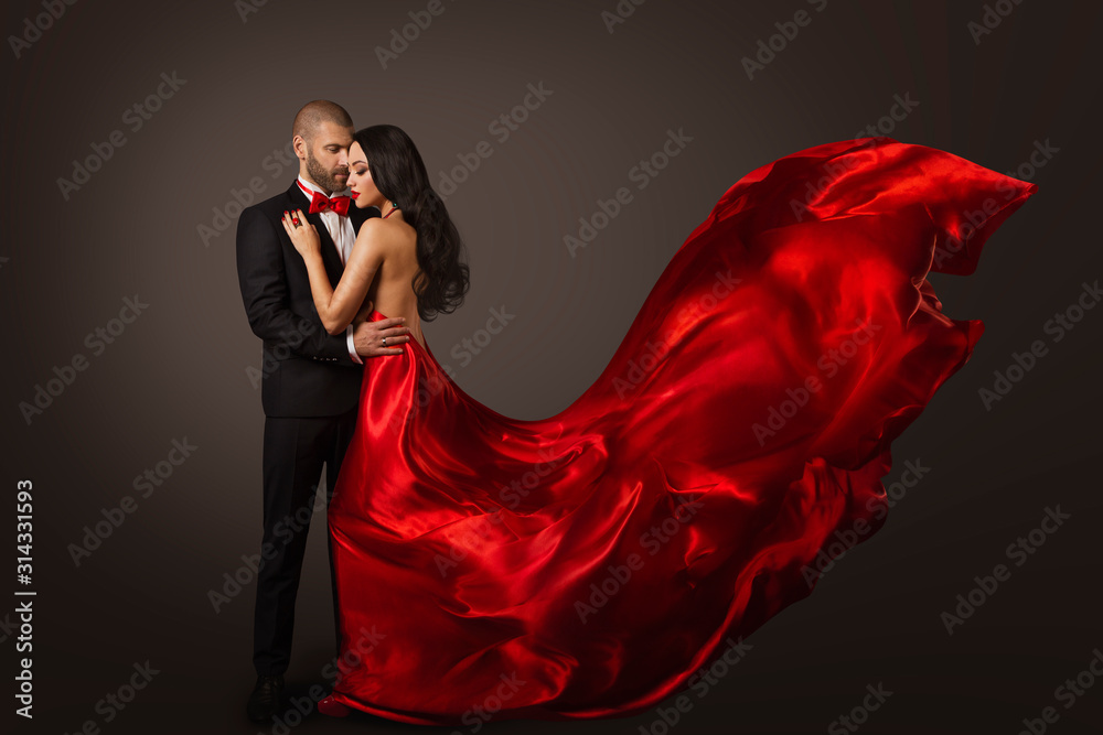Fototapeta Couple Beauty Portrait, Beautiful Woman Dancing in Red Dress and Elegant Man, Cloth Fluttering on wind