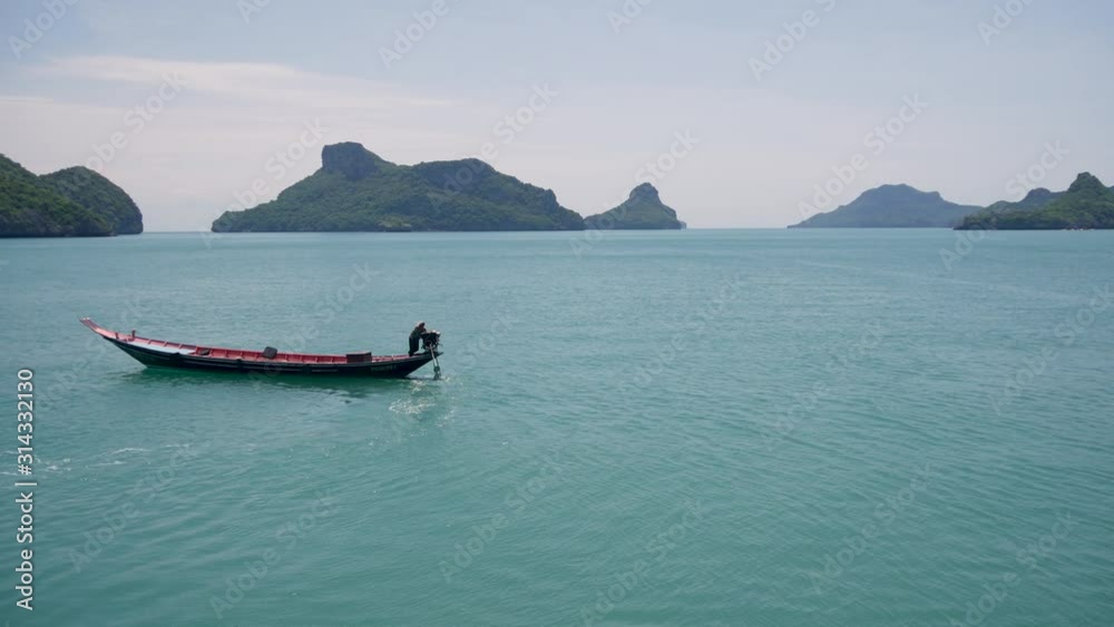 Group of Islands in ocean at Ang Thong National Marine Park near touristic Samui paradise tropical resort. Archipelago in the Gulf of Thailand. Idyllic turquoise sea natural background with boat. Group of Islands in ocean at Ang Thong National Marine Park near touristic Samui paradise tropical resort. Archipelago in the Gulf of Thailand. Idyllic turquoise sea natural background with boat.