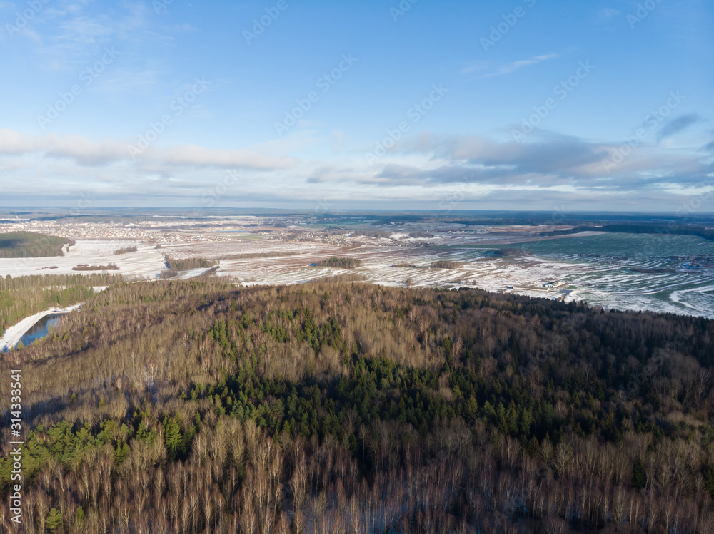 Winter nature, forest, river, village. View from above. Shooting from a copter.