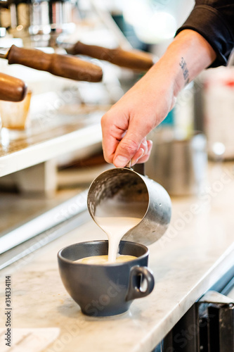 Barista making coffee latte