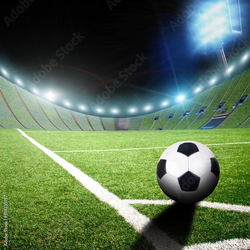 Football stadium with a ball on a corner of a field with grass and lights with flashes © Dmitry Perov