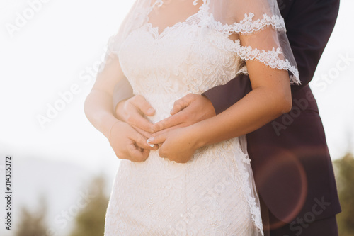 Front view of corps of groom which is hugging bride