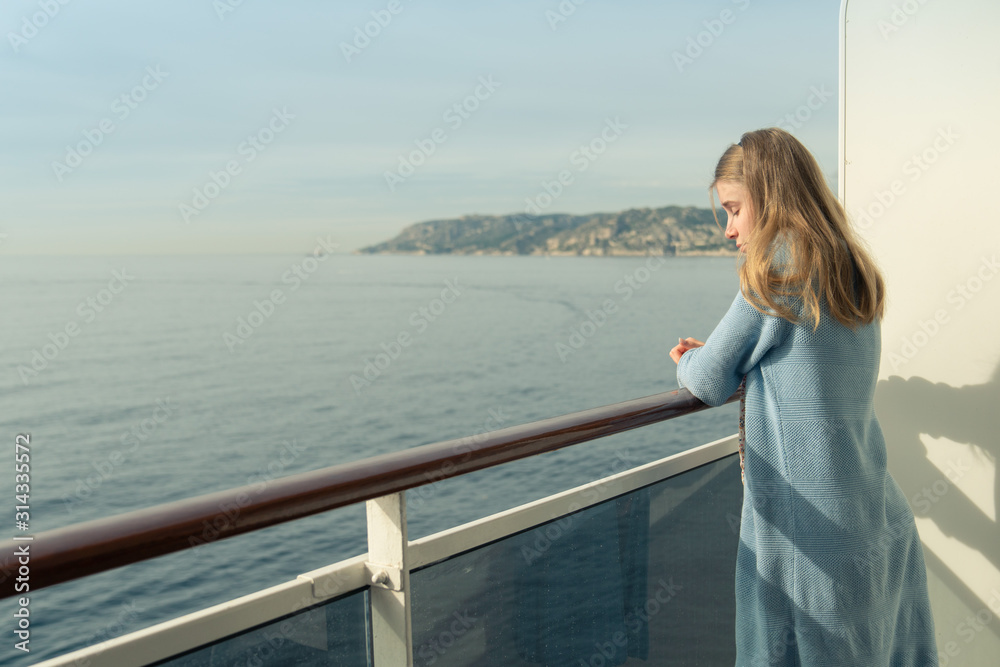 Cruise ship vacation. Teenager girl relaxing on luxury cruise ship balcony