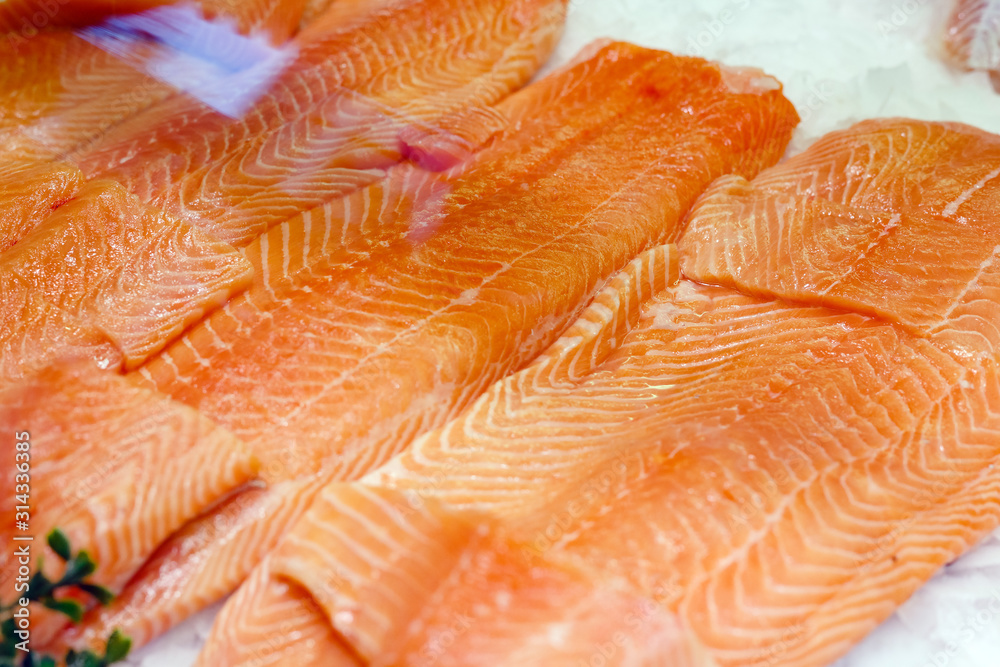 Raw salmon Fish fillet steak on ice at the fish market. Large assortment of fresh seafood, Norwegian salmon fillet. Keto food and healthy nutrition concept. Raw salmon Fish fillet steak on ice at the fish market. Large assortment of fresh seafood, Norwegian salmon fillet. Keto food and healthy nutrition concept.