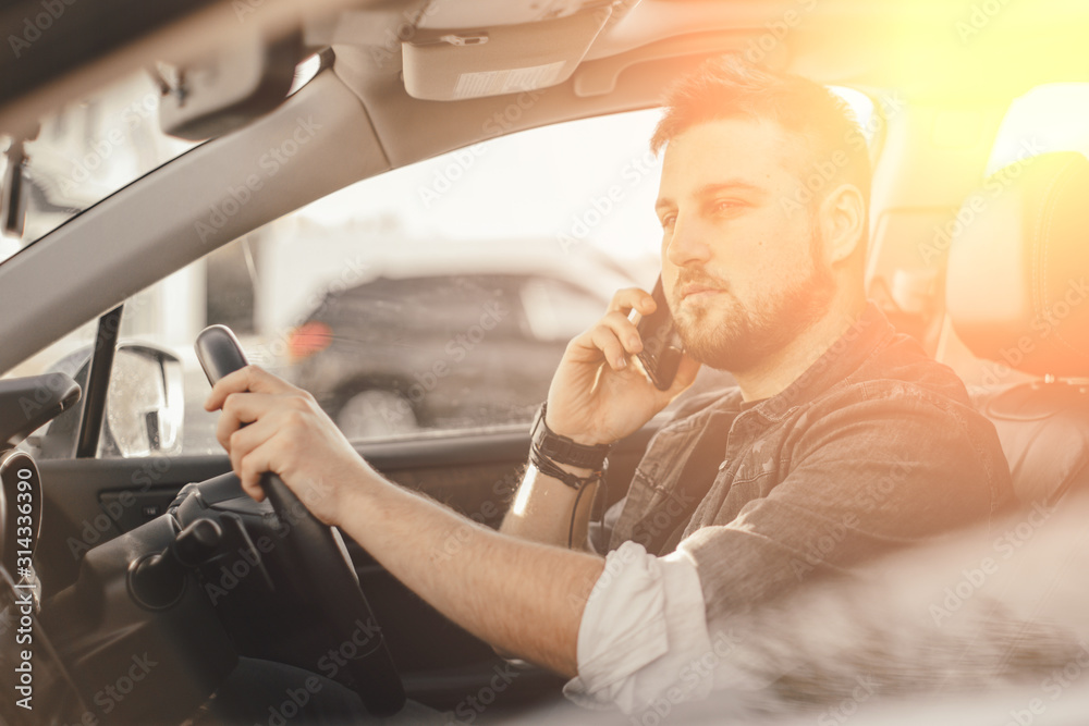Young handsome driver man with smartphone serfing internet and drink black coffee Young handsome driver man with smartphone serfing internet and drink black coffee