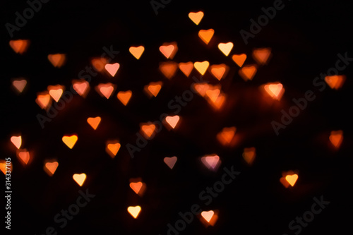 Bokeh in the form of hearts on a black background
