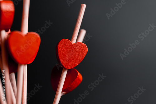 toothpicks with small red hearts on a black background. St. Valentine s Day