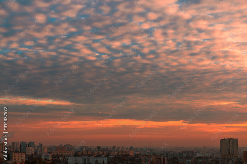Beautiful sky with clouds over the city at sunset