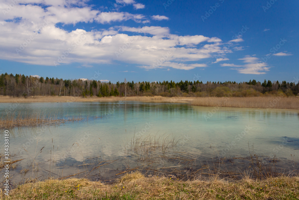A lake in Russia with very clear azure water. Spring landscape with lake and blue sky.