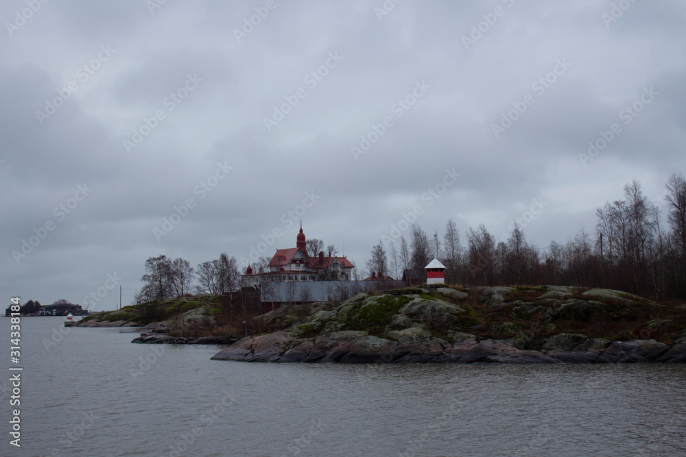 Small inhabited rocky islands with houses and trees, which are many located around the city of Helsinki in Finland.
