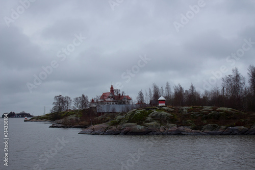 Small inhabited rocky islands with houses and trees, which are many located around the city of Helsinki in Finland. © NATALIA