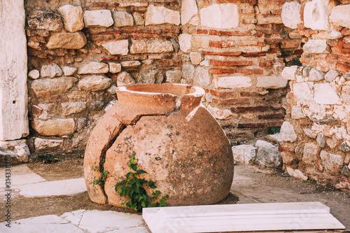 Antique city of Ephesus. Ruins of an ancient city in Turkey. Archaeological site, expedition.Remains of an ancient Greek city in the mountains.Ruins of the buildings. Broken clay vessel.Big old vase.