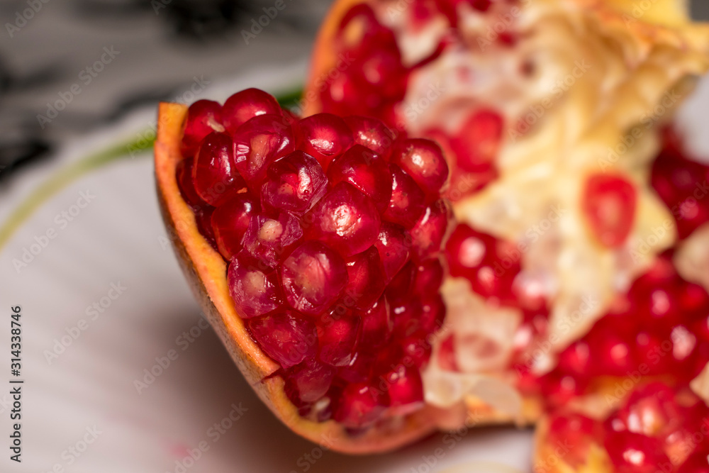 ripe juicy pomegranate with no seeds on the plate ripe juicy pomegranate with no seeds on the plate