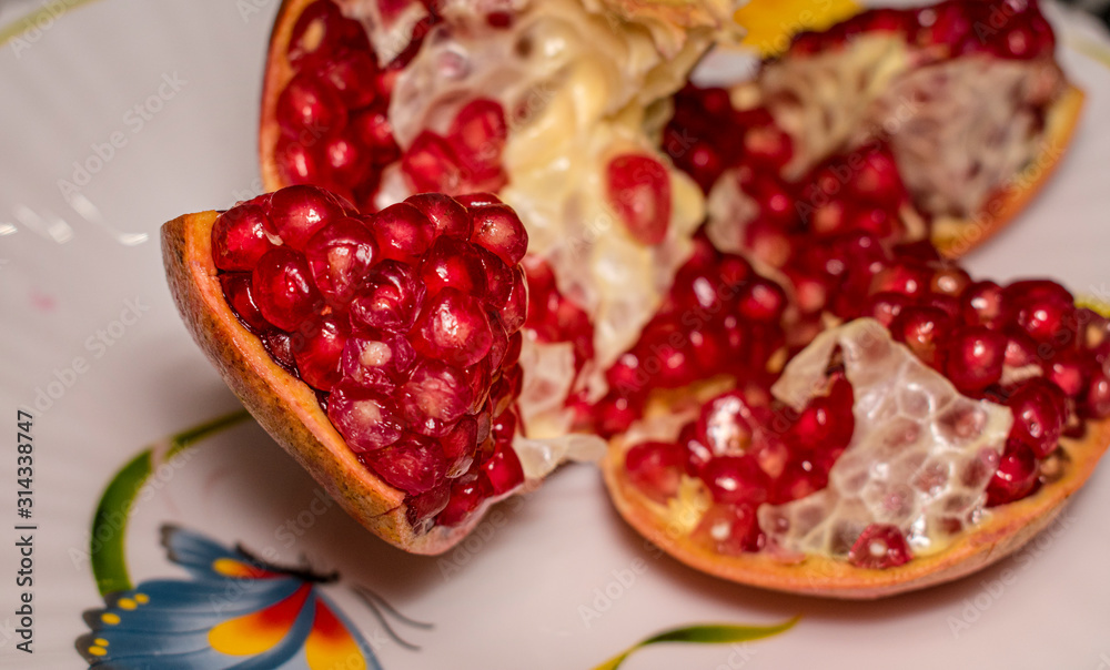 ripe juicy pomegranate with no seeds on the plate ripe juicy pomegranate with no seeds on the plate