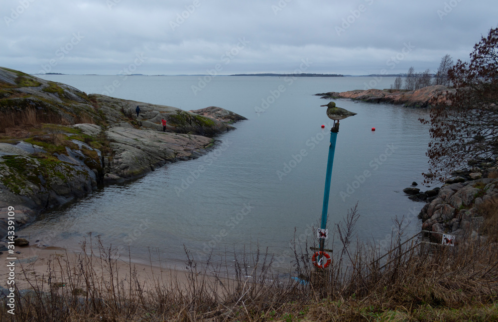 A bay on the island of Suomenlinna surrounded by granite shores on an autumn day near the city of Helsinki in Finland.