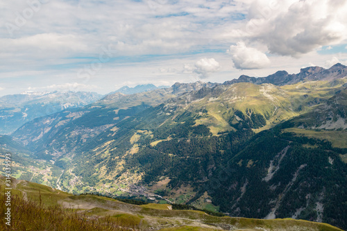 Beautiful high angle view on the Anniviers valley with some picturesque alpine villages seen from top of Sorebois on a cloudy summer day. Zinal, Val d' Anniviers, Switzerland