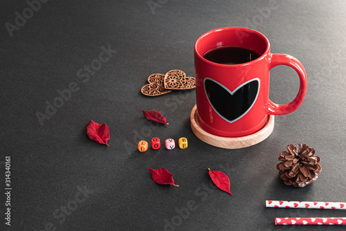 Wallpaper Mural Red sweet heart coffee cup, colorful LOVE cube boxes, decor wood hearts, pieces of flower, pine cone, heart straws on black background with nature sunlight Torontodigital.ca