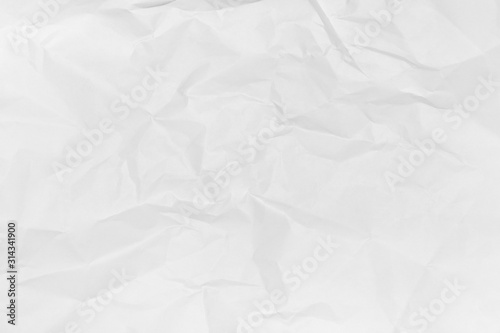 Crumpled paper background of white colour. Creative minimal flat lay. View from above.