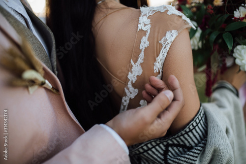 Details of wedding couples clothes, bride and groom, back view