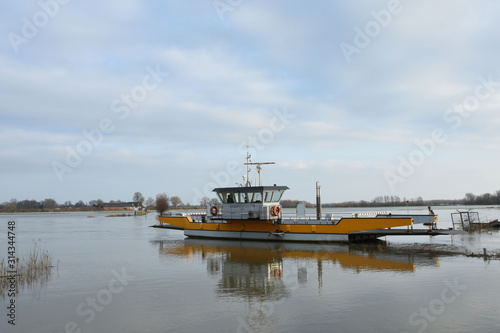 ferry waiting on flooded meadow near river IJssel