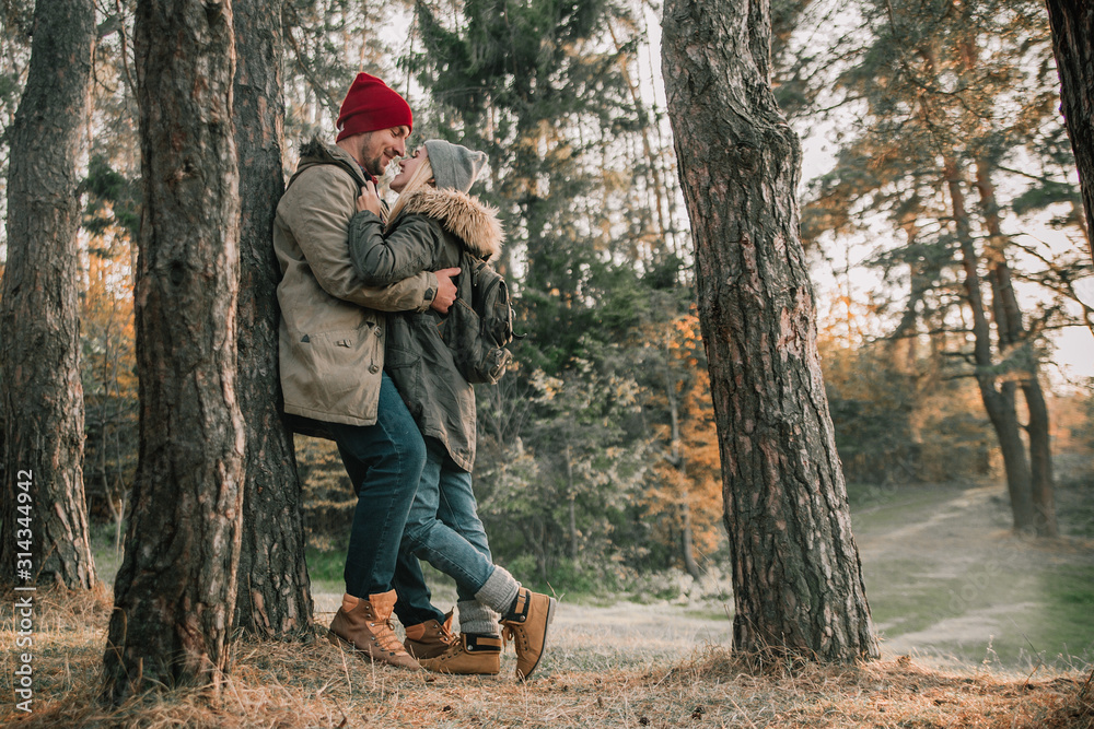 Hiking couple with backpack walking in the forest and exploring outdoors. Freedom and active travel concept. Hiking couple with backpack walking in the forest and exploring outdoors. Freedom and active travel concept.