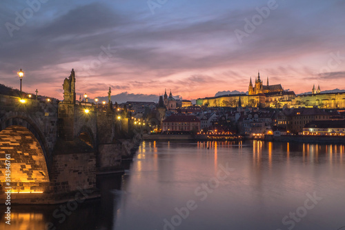 view of famous charles bridge and prague castle at sunset